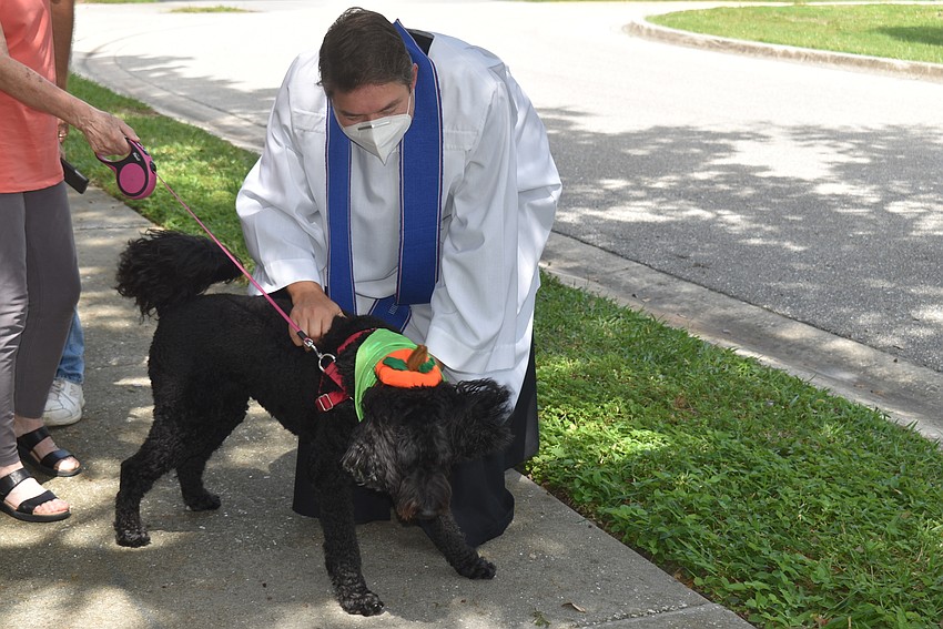 Father Dave Marshall blesses Reba.