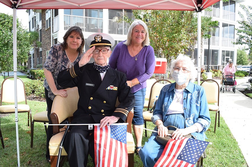 Joy Bragg and her father, Roger Quisenberry, sister Jan Wright and mother, Margaret Quisenberry are overwhelmed by the number of people in the parade to celebrate Roger Quisenberry's 100th birthday.