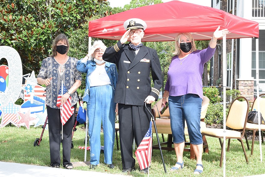 Joy Bragg and her mother, Margaret Quisenberry, father, Roger Quisenberry, and sister Jan Wright, wave to people as they come through the parade.