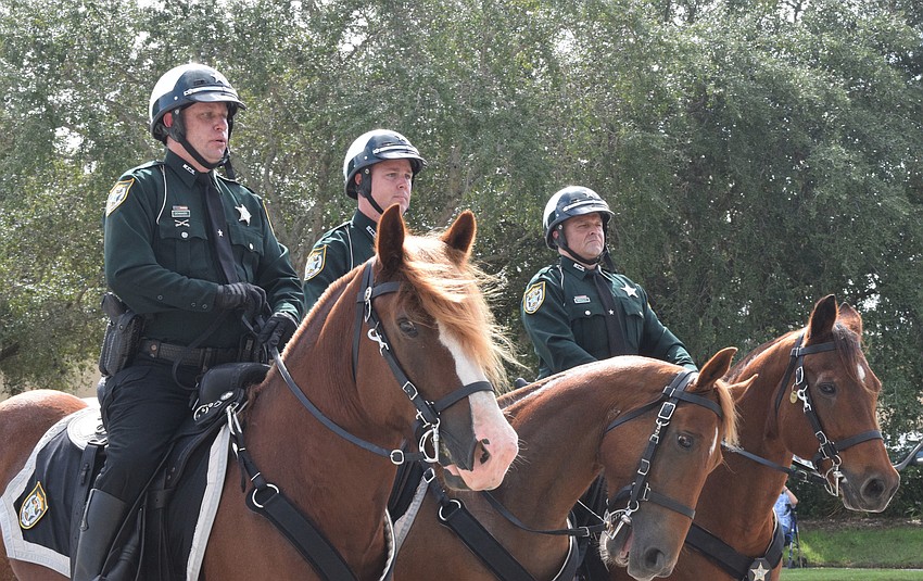 Dep. John Demark, Det. Robert Myer, and Dep. Alan Wright of the Manatee County Sheriff's Office lead the parade on horseback.