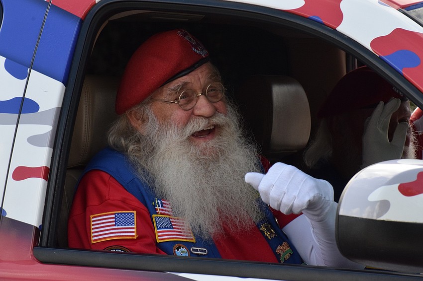 Steve Hadala with the Santa Claus Drill Team gives a thumbs up during the parade.