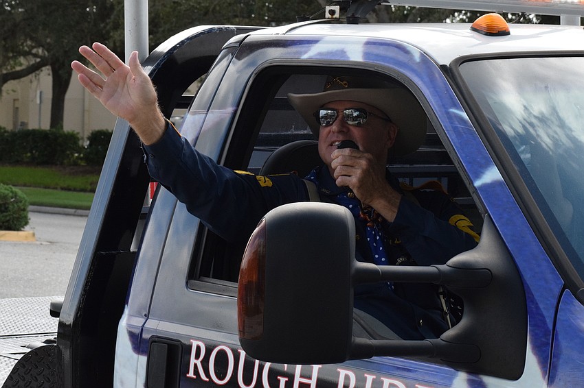 William Kiessel with the Rough Riders waves as he goes through the parade.