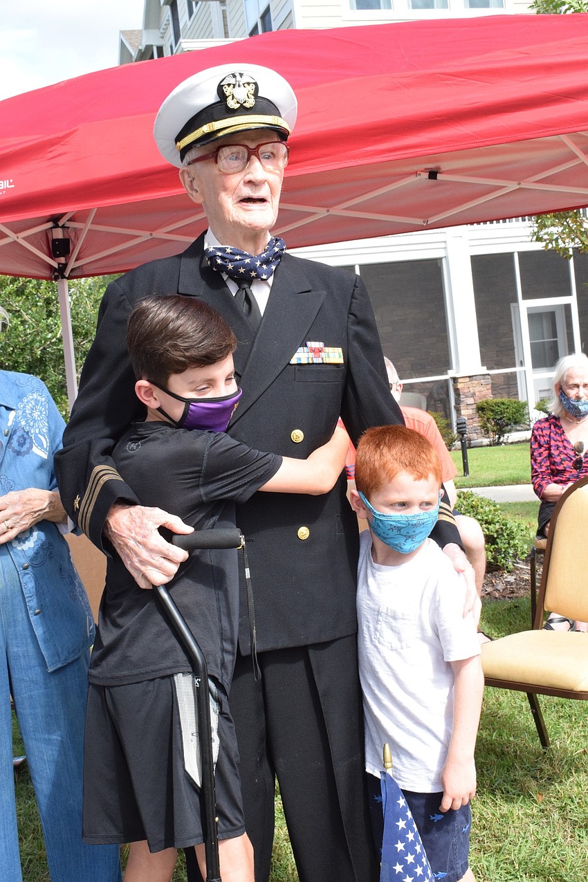 Roger Quisenberry (center) hugs his grandsons Jackson Quisenberry, who is 9, and Aiden Quisenberry, who is 5.