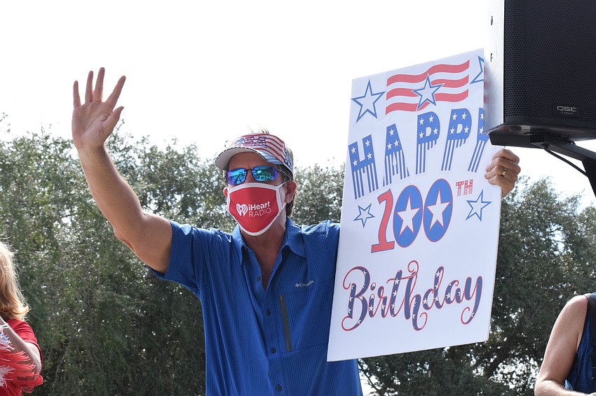 David Jones with 107.9 WSRZ holds up a giant birthday card and waves while 