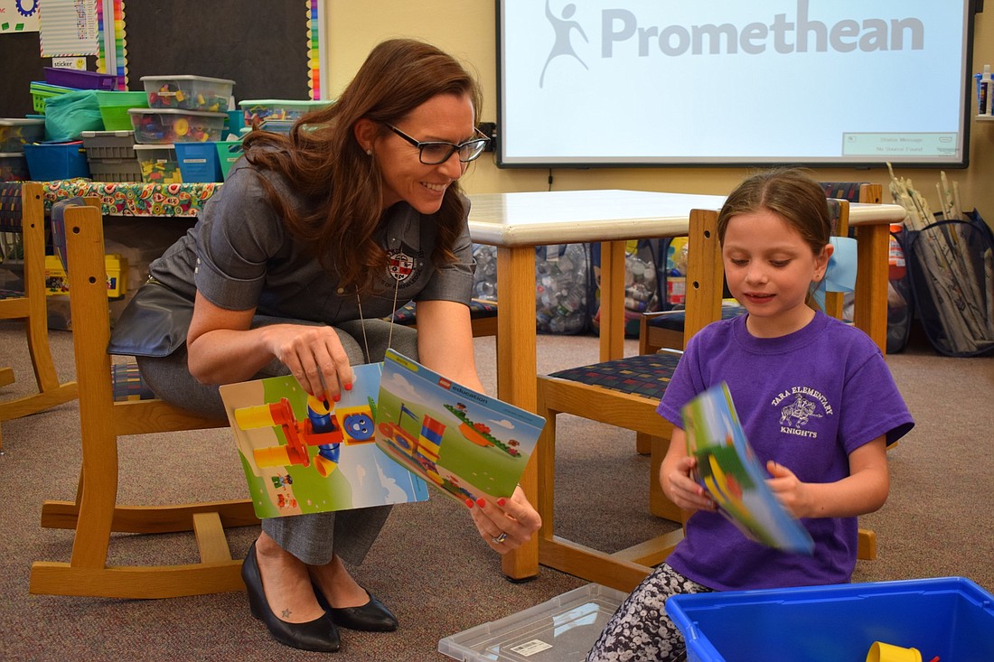 Laura Campbell, principal at Tara Elementary School, works with Averyanna Rivera on constructing a tower. Much like these towers, Tara Elementary will undergo construction during a renovation of the school. File photo.