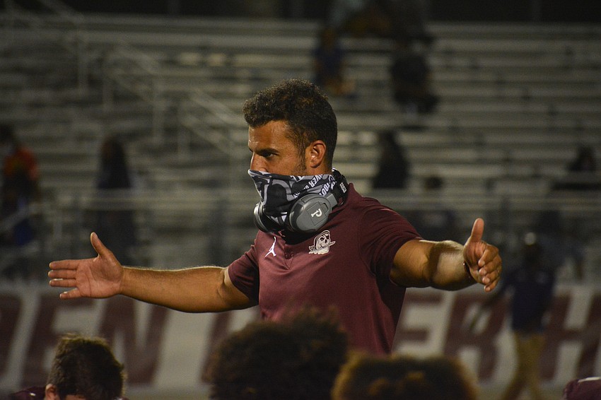 Pirates Coach Curt Bradley talks to his team following the shutout win.