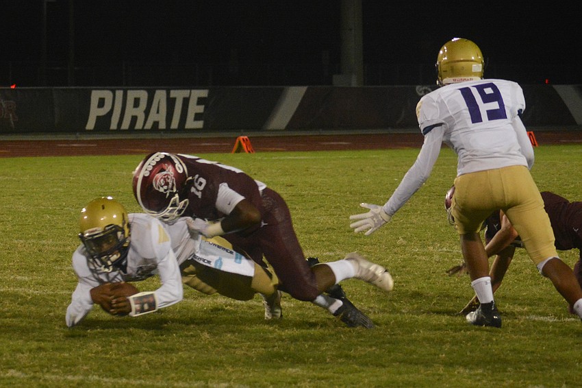 Braden River junior linebacker Justice McDaniel sacks Booker quarterback King Winkfield.