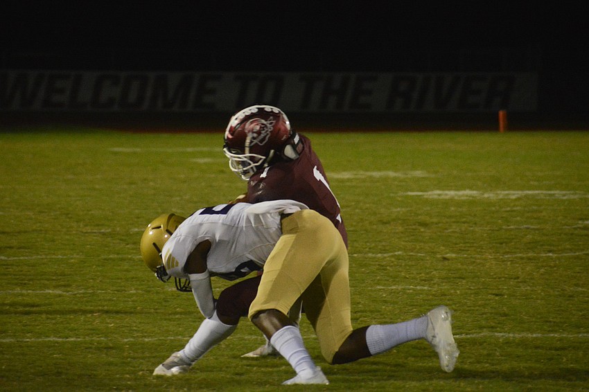 Jaheim Hodo (1) lowers his shoulder into a Booker defender.