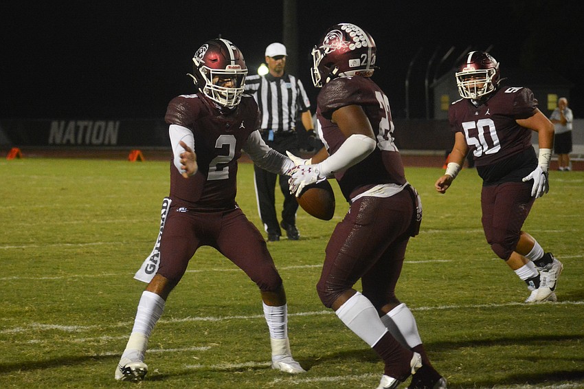 Shawqi Itraish congratulates Lavontae Youmans after a Youmans touchdown run.
