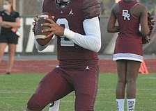 Pirates senior quarterback Shawqi Itraish warms up before taking on Booker.