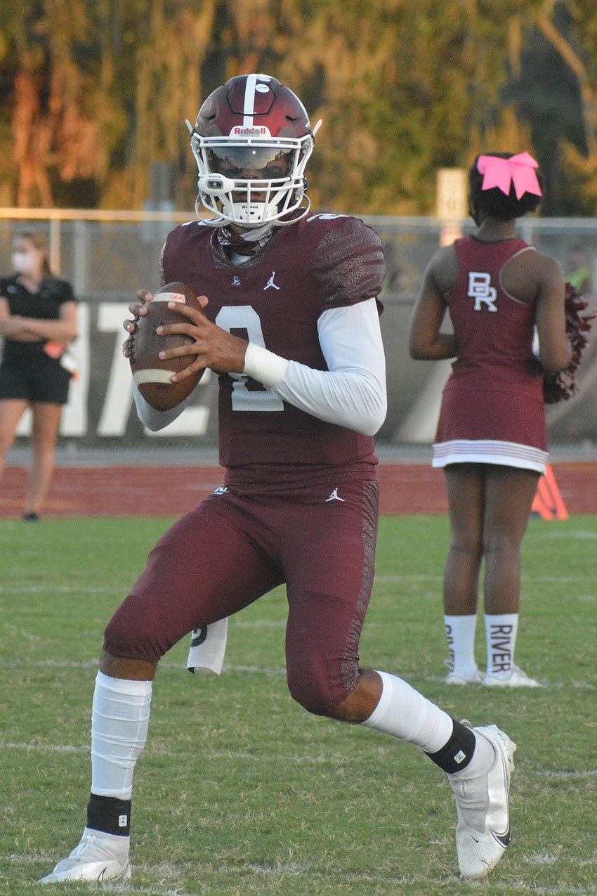 Pirates senior quarterback Shawqi Itraish warms up before taking on Booker.