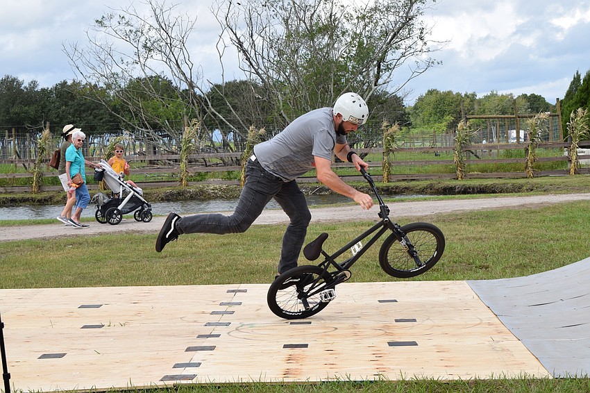 Scott Weaver with BMX Trick Stars does a maneuver on his bike before the start of the show.