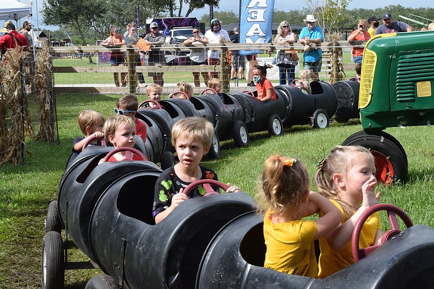Children take a ride on a train during the 29th annual Hunsader Farms Pumpkin Festival.
