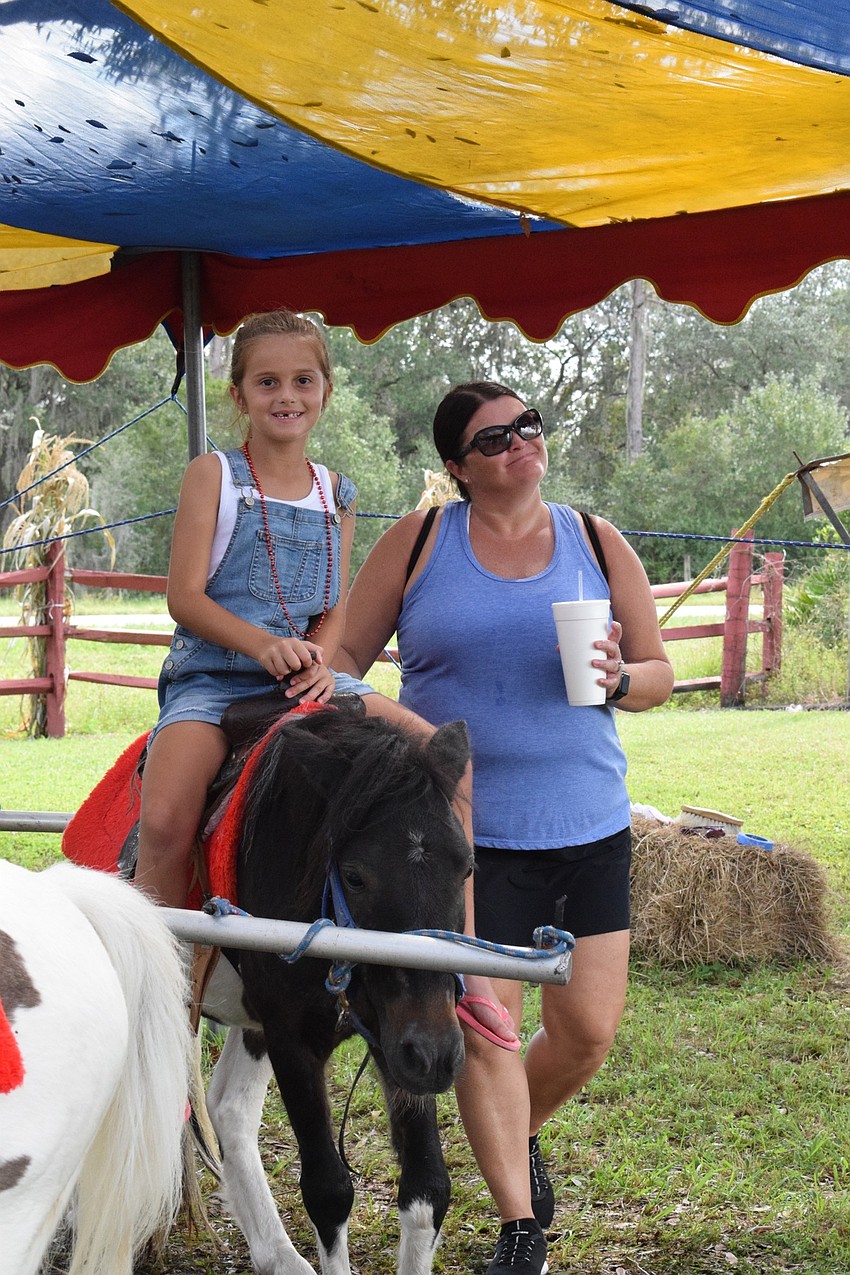 GreyHawk Landing's Lauren Bittar, who is 7, and Kim Bittar enjoy the pony ride together.