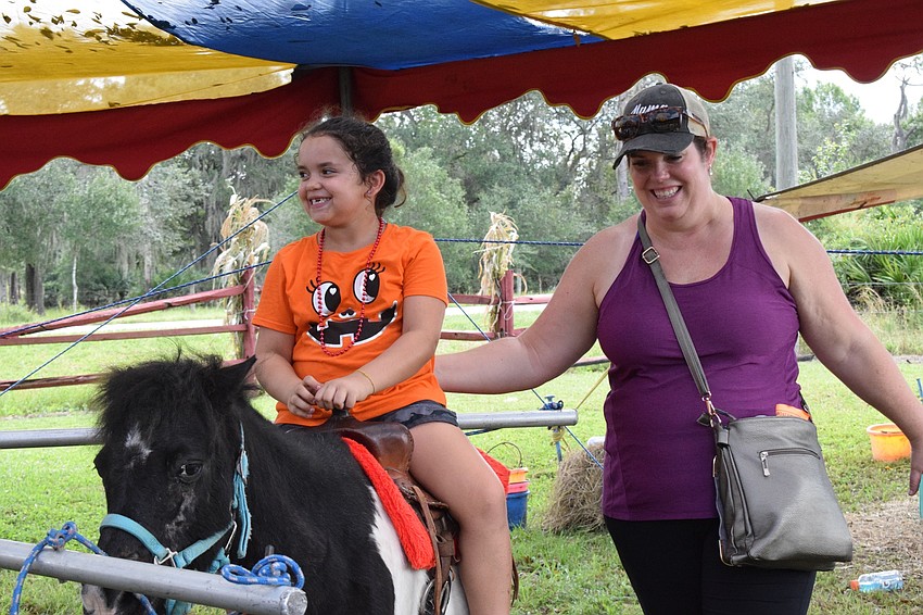 Lakewood Ranch's Aurelia Yepez, who is 7, enjoys riding a pony alongside her mother, Amy Yepez. 