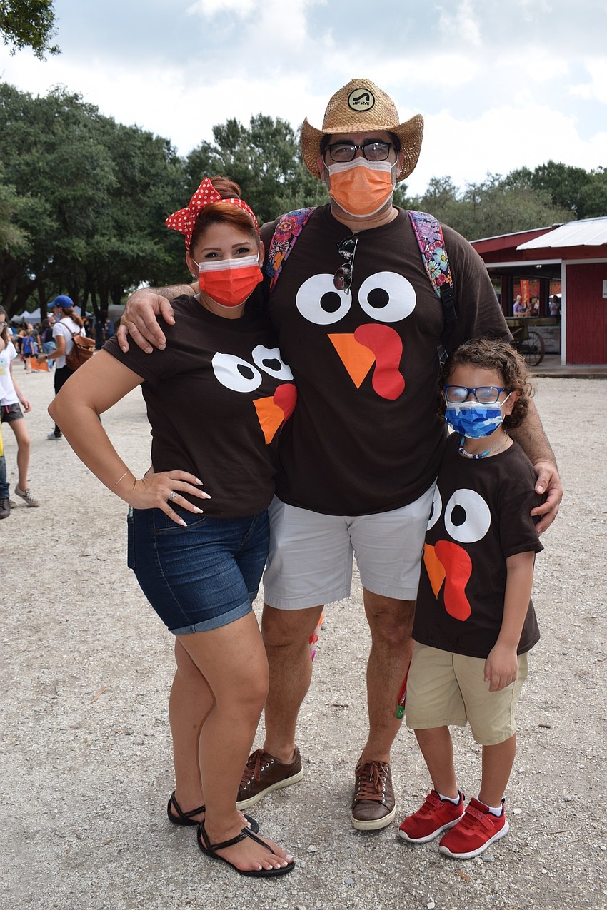 Valrico's Elaine and Salvador Pelaez dress in matching turkey shirts with their 7-year-old son Lucas Camacho-Berrios.