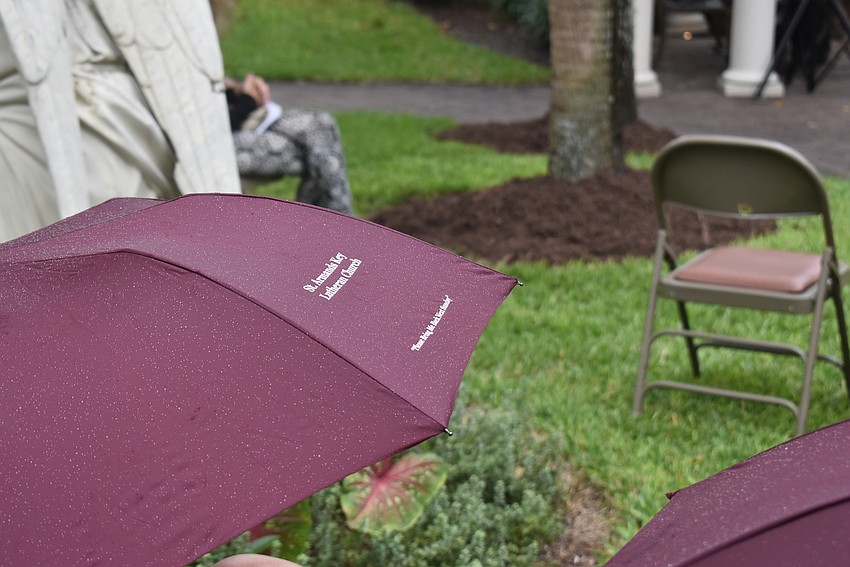 The church handed out their umbrellas to keep concertgoers dry.