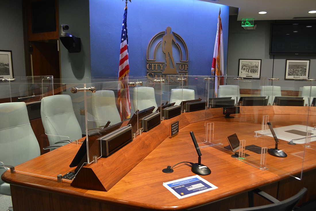 City staff has already installed plexiglass dividers at the commission table in advance of a return to in-person meetings.