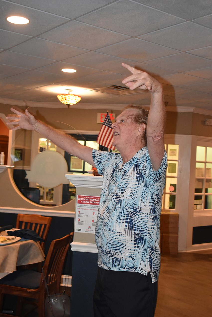 Jim Whitman led the group in song before the meeting.