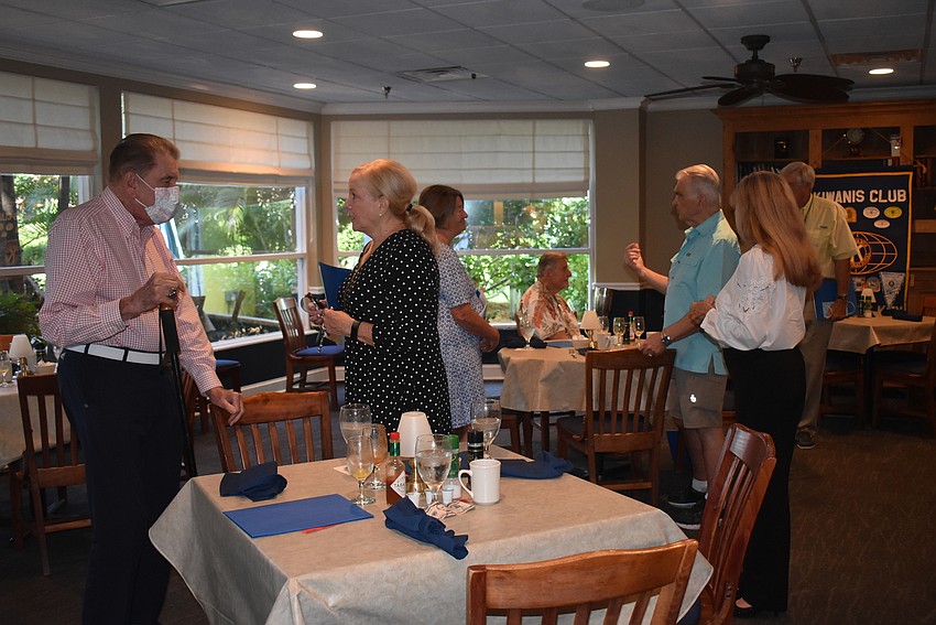Members mingled after the meeting ended.