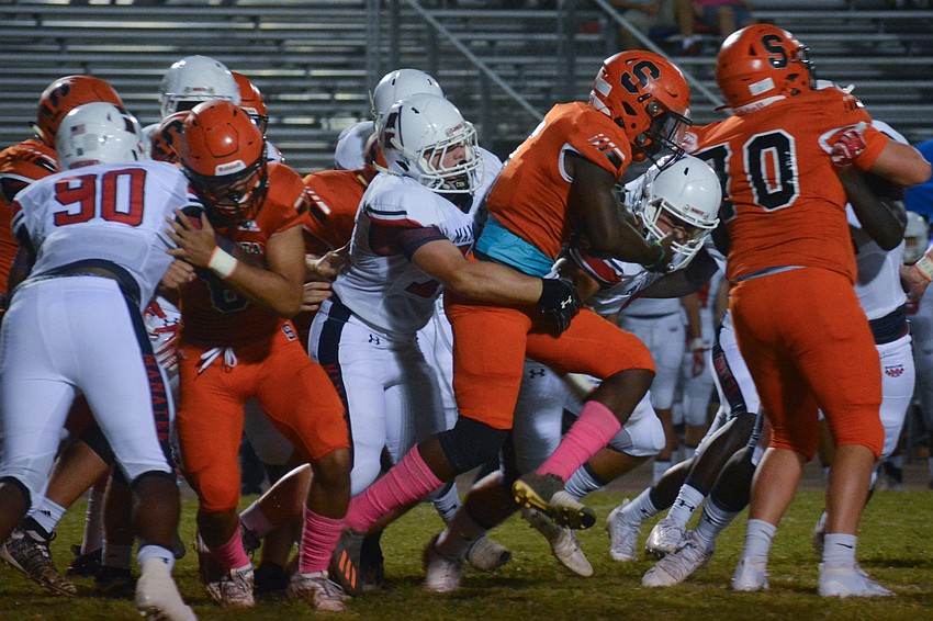 Jarmel Holloway runs through the Manatee defense.