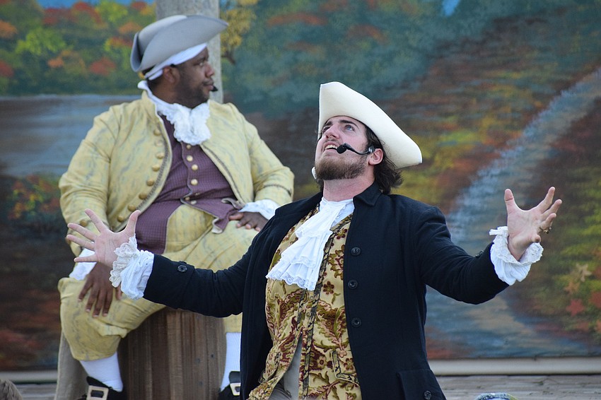 Mr. Bantus Van Tassel (Eldred Brown) listens as Brom Bones (Tanner Fults) shares how he was almost killed by the Headless Horseman.