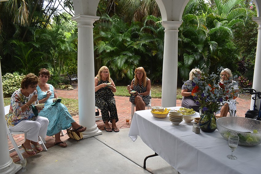 The attendees gathered and balanced plates on their knees.