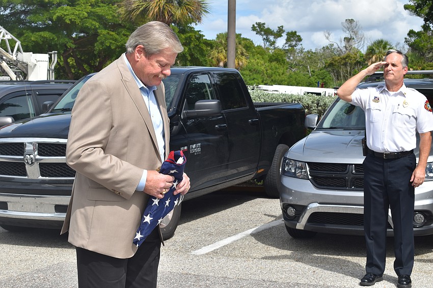 Fire Chief Paul Dezzi (right) saluted retiring Police Chief Pete Cumming on Friday afternoon.