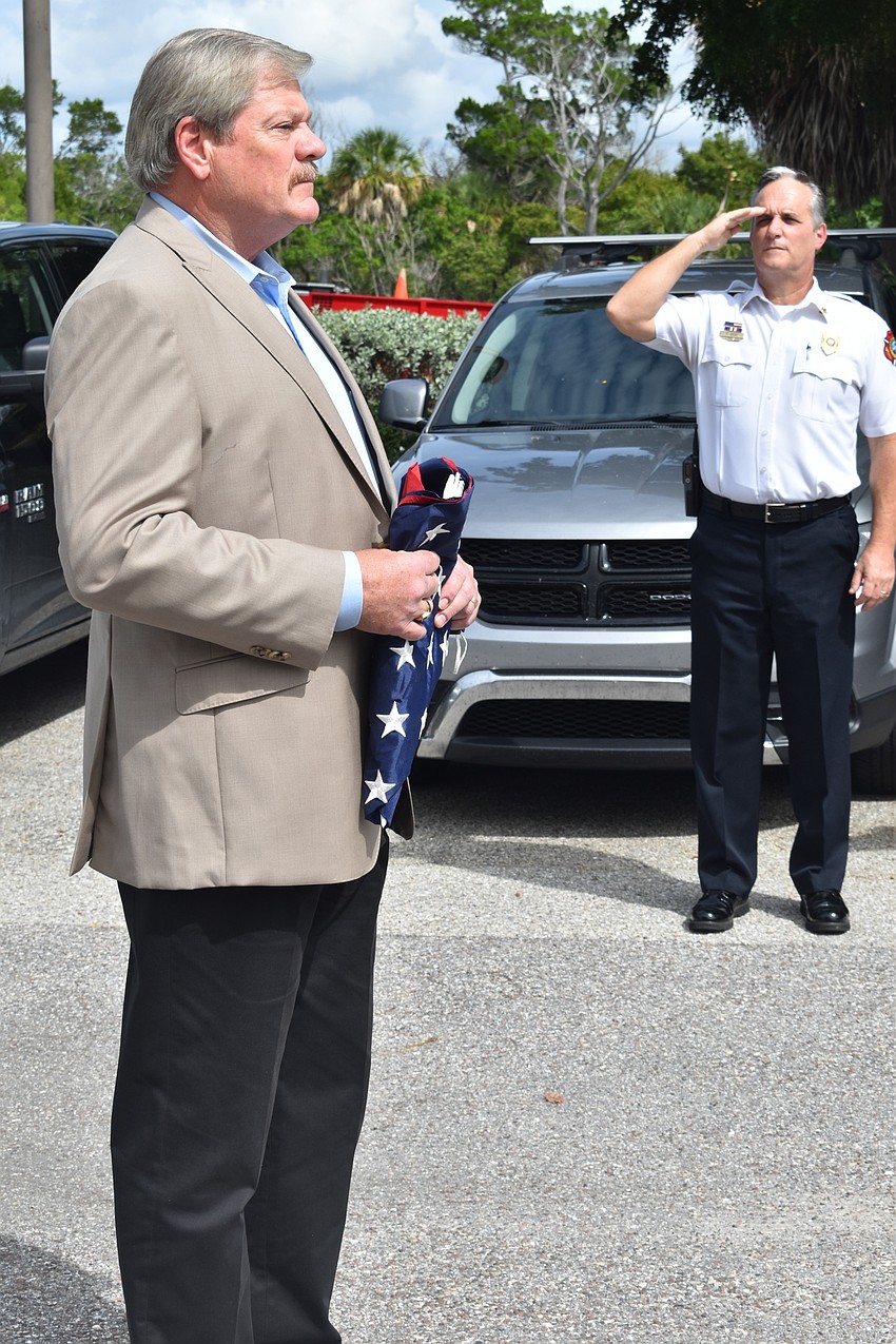 Fire Chief Paul Dezzi (right) saluted retiring Police Chief Pete Cumming on Friday afternoon.