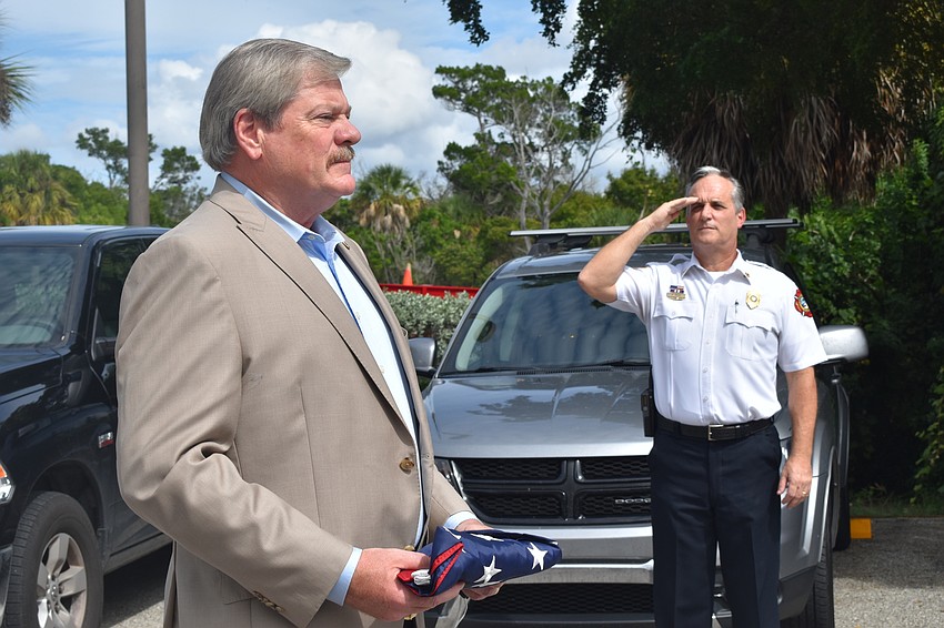 Fire Chief Paul Dezzi (right) saluted retiring Police Chief Pete Cumming on Friday afternoon.