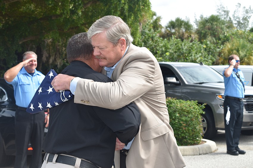 Deputy Police Chief Frank Rubino presented retiring Police Chief Pete Cumming with an American flag on Friday afternoon.