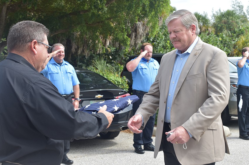 Deputy Police Chief Frank Rubino presented retiring Police Chief Pete Cumming with an American flag on Friday afternoon.