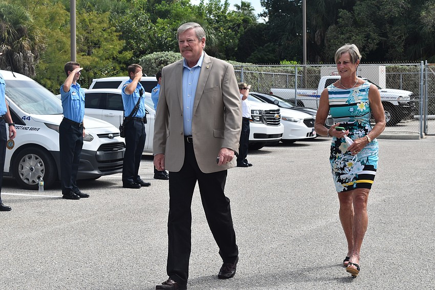 Police officers and firefighters saluted Pete Cumming and his wife Diane as they drove off together in retirement.