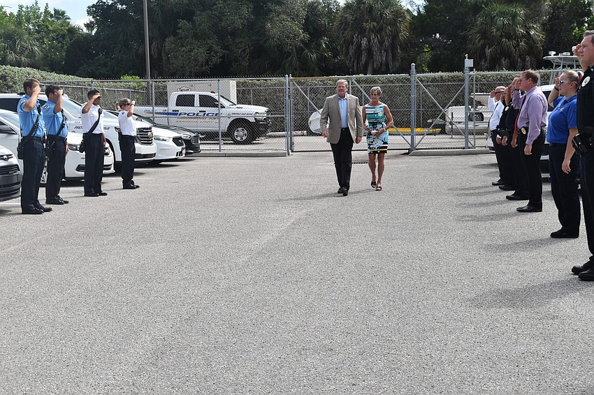 Police officers and firefighters saluted Pete Cumming and his wife Diane as they drove off together in retirement.