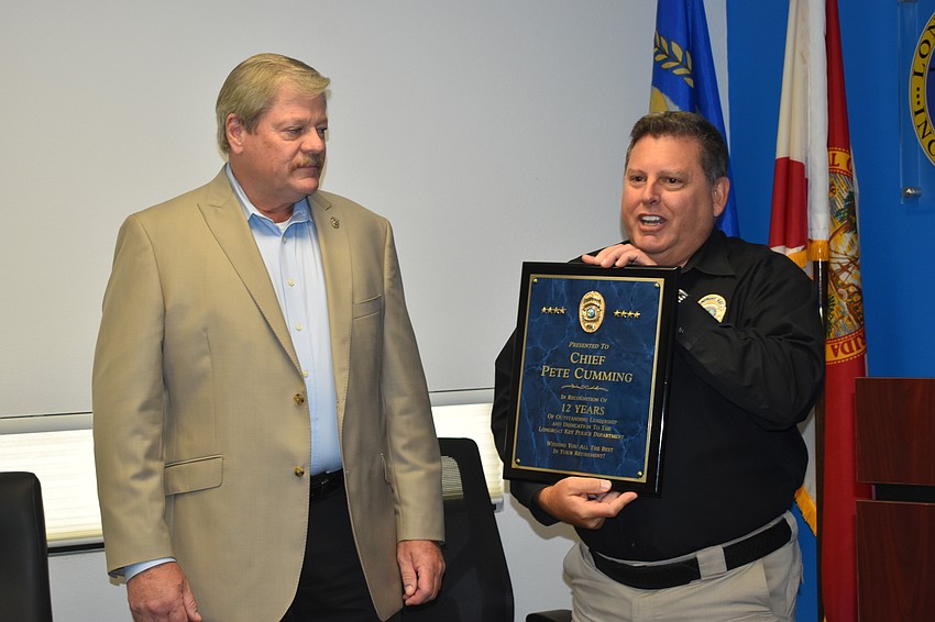 Deputy Police Chief Frank Rubino (left) presented retiring Police Chief Pete Cumming (right) with a commemorative plaque on Friday afternoon.