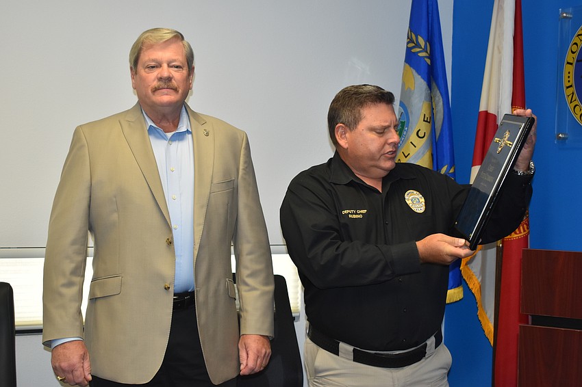Deputy Police Chief Frank Rubino (left) presented retiring Police Chief Pete Cumming (right) with a commemorative plaque on Friday afternoon.