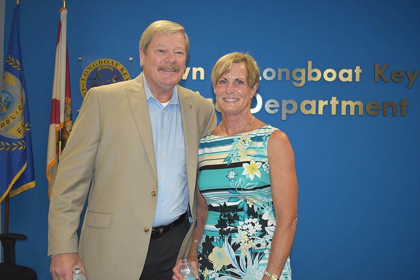 Pete Cumming and his wife Diane pose for a picture during Friday afternoon's retirement ceremony.