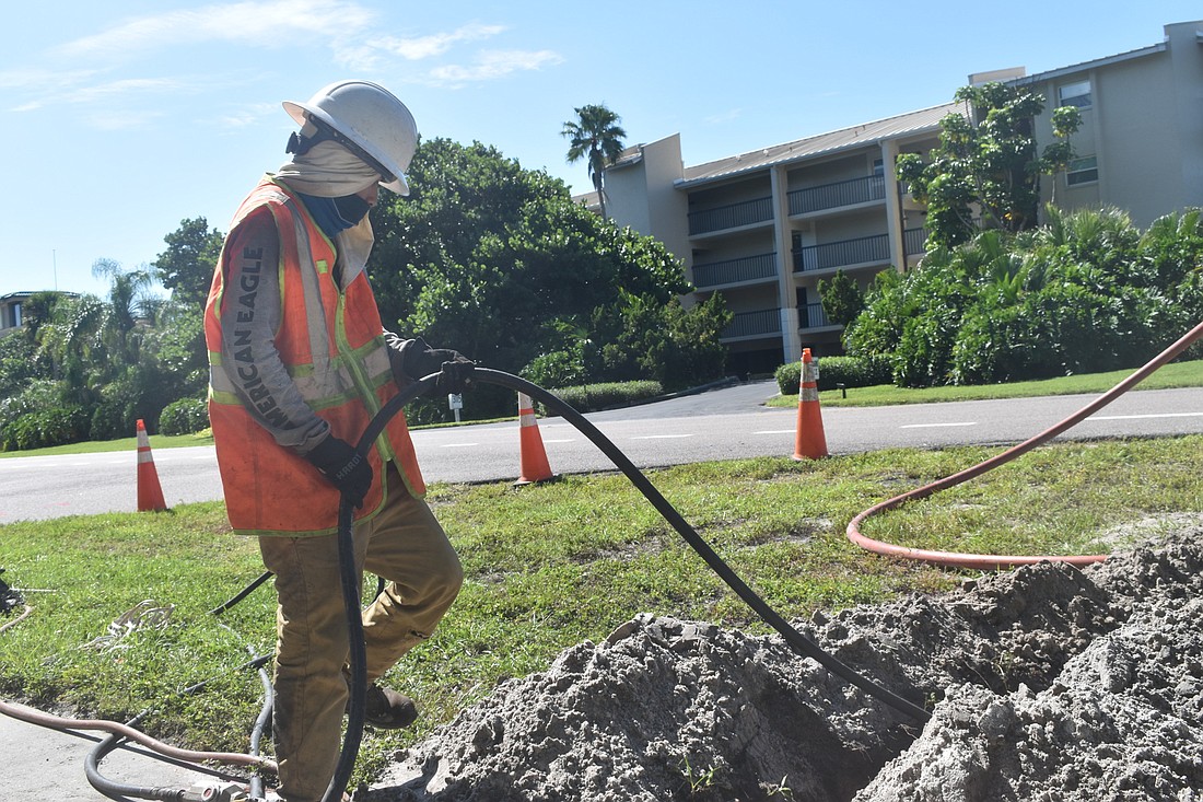 A Wilco Electrical LLC employee works on the town's underground utilities project along Gulf of Mexico Drive.