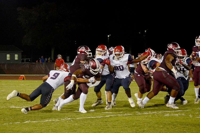 Lavontae Youmans (22) runs through a hole.