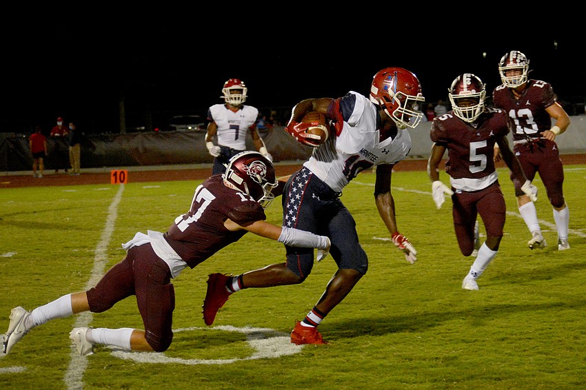 Braden River's Matt Manning dives to make a tackle on Manatee's Irone Jackson.