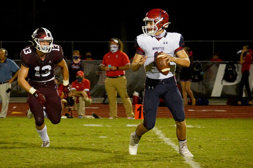 Braden River's Carson Goda (13) chases down Manatee quarterback Jayse Berzowski.