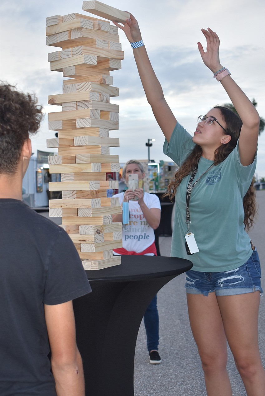 Nala Gato (right) finishes her move in a game of Jenga against Mark Parsons (back to camera). Gato won after a 15- to 20-minute battle.