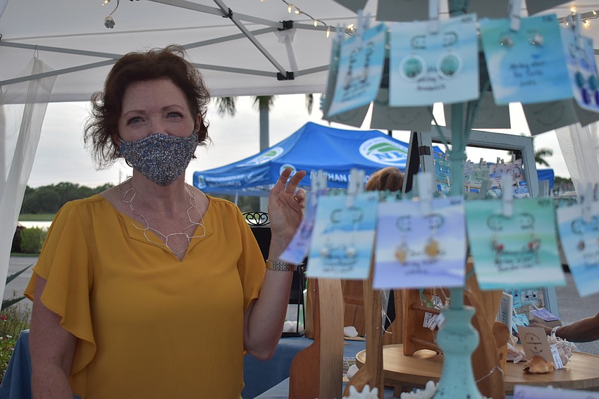 Kim Schmeits, owner of Sugar Sand Silver, sells jewelry at Fiesta Friday. Schmeits often sells her products at the Sarasota Farmers Market.