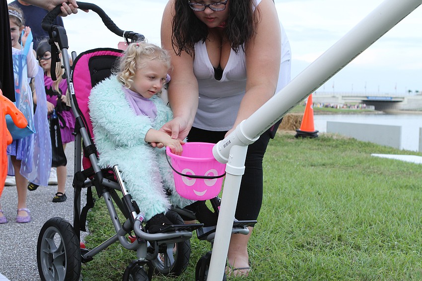 Kinsley Reeder picked up candy from a tube.