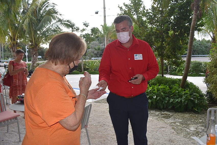 Gail Loefgren takes a card from Matt Michala.