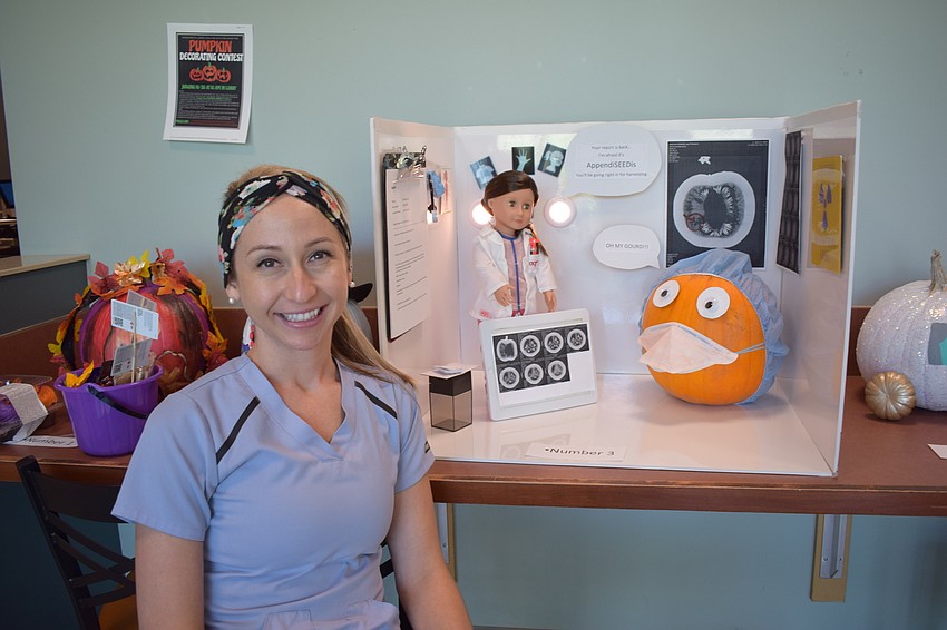 Ashley Dillon of the radiology department accepted the Cutest award for the department's display.