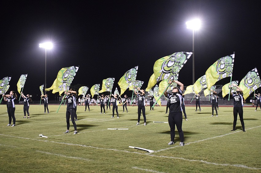 The color guard practices before it performs with the band during the Community Night Showcase.