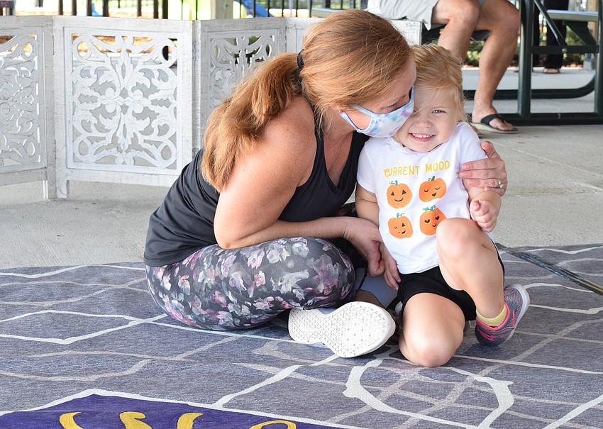 River Walk's Jennifer Zych hugs her 2-year-old daughter Avery Zych before class begins.