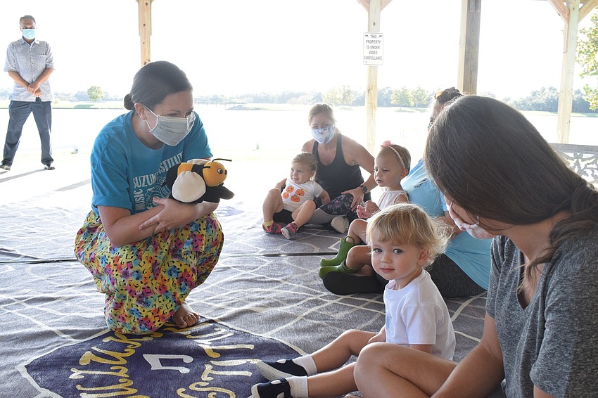 Amy Lemon, the instructor of the Mommy and Me Music Class, sings a hello song to the children and mothers at the beginning of class.