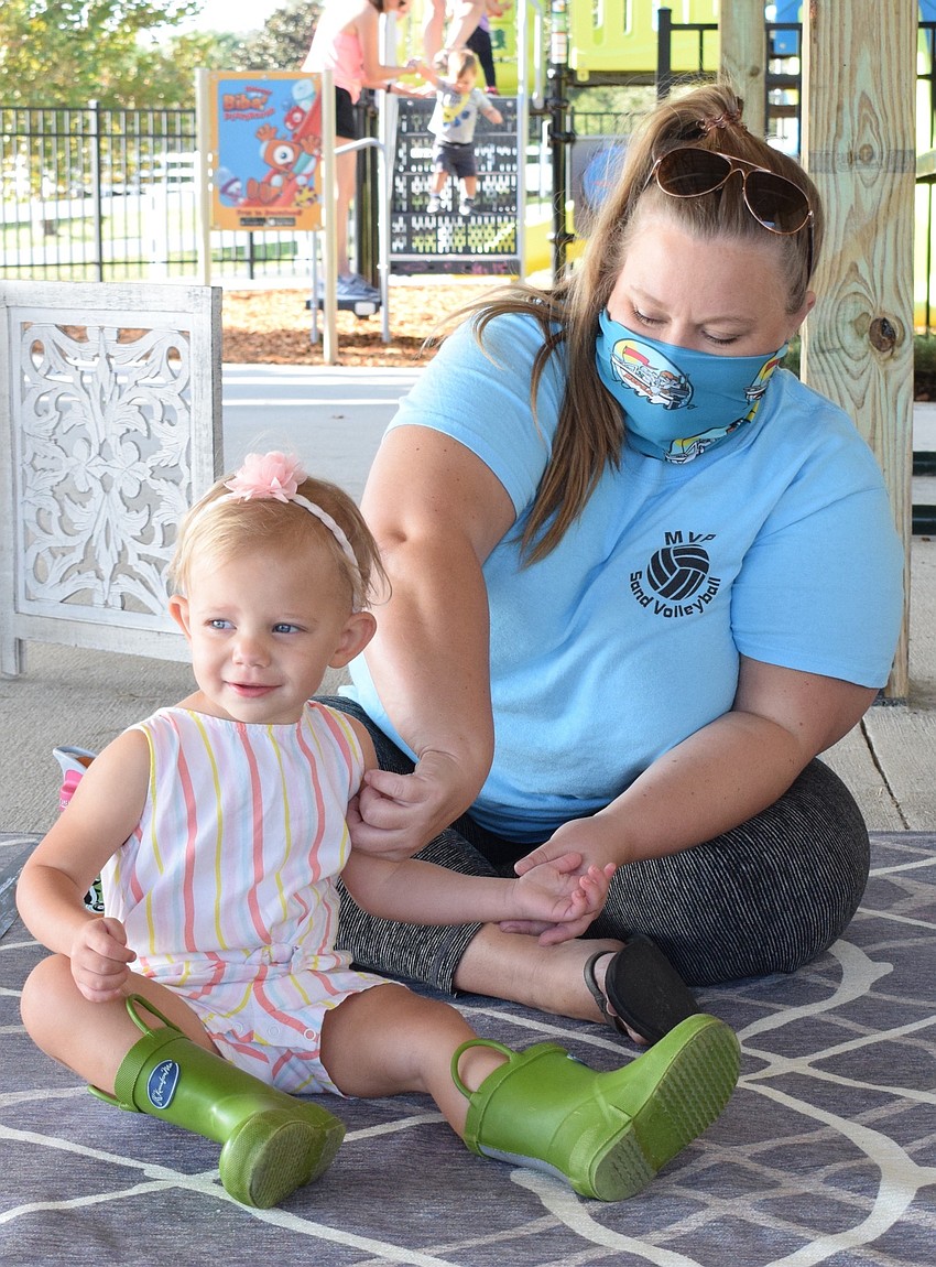 Harmony's Josie McComas, who is 1, gets tickled by her mother, Jessi McComas.
